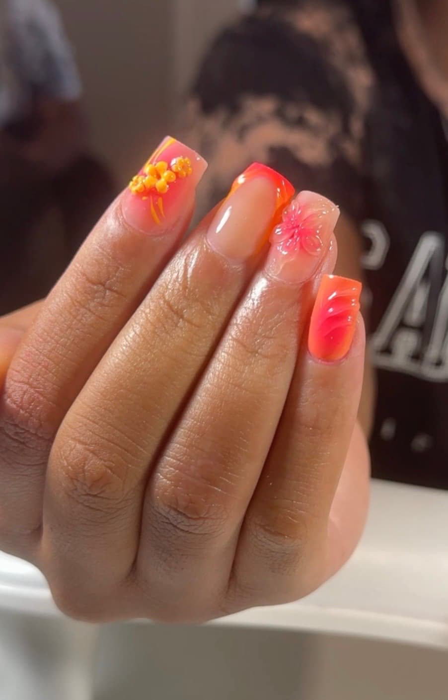 Coffin extensions blended from coral to orange with sculpted floral accents